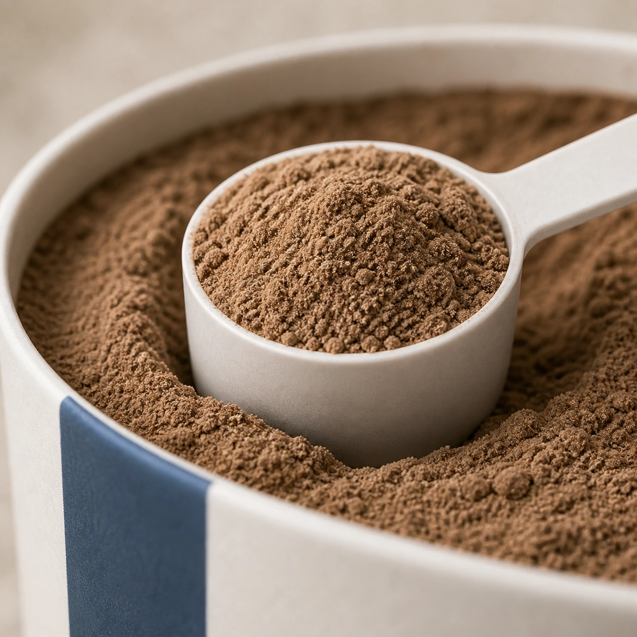 Macro view of a scoop of Clarity Mushroom powder inside its canister.