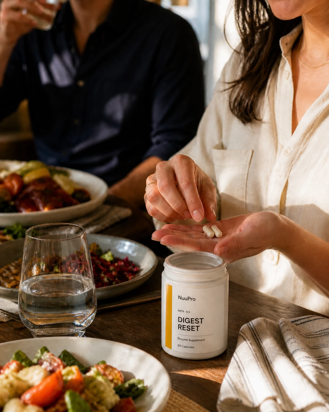 A customer holding two NuuPro Digest Reset capsules beside an everyday meal.